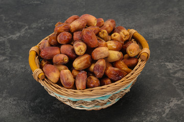 Fototapeta na wymiar Sweet tasty dry dates in the basket