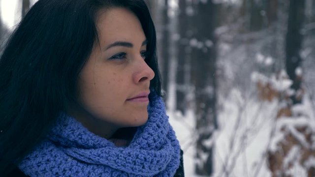 Portrait Pretty Serious Girl Thinking and Looking Up On Sky. Vacation On Winter Holidays. Winter Forest During Snowfall. Frost Weather Snow Covered Trees In Wood. Slow motion 60 fps