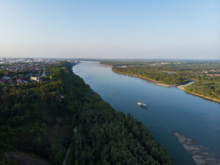 Obraz premium Aerial view of big siberian Ob river and ship, summer day, drone shot