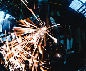 Metal grinder in home shed workshop creating sparks