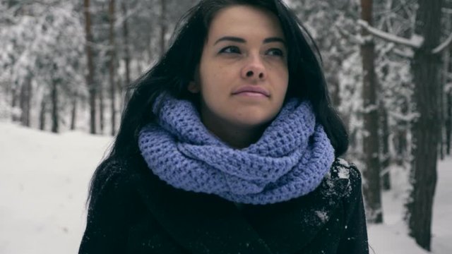 Portrait Pretty Serious Girl Thinking and Looking Up On Sky. Vacation On Winter Holidays. Winter Forest During Snowfall. Frost Weather Snow Covered Trees In Wood. Slow motion 60 fps