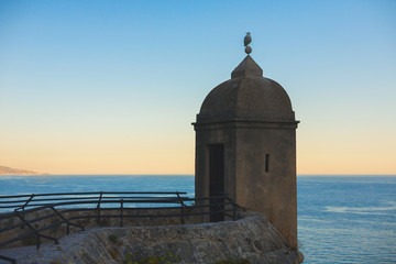 Fototapeta na wymiar medieval observation tower on the background of the evening sea. Monaco