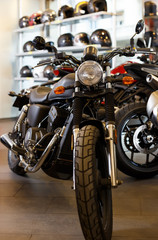 View of range motorcycles parked in showroom for sale