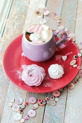 Cup of coffee with meringues and marshmallows on a red plate, hearts, illumination, against the background of a window, homeliness, Valentine's day, romantic greeting, happy birthday