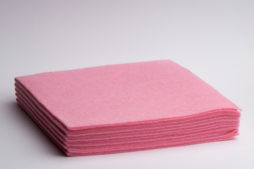 Pink microfiber cloths in a stack on a white background. Housewares.