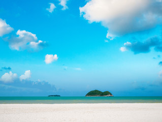 White sand beach with blue sky over sea