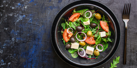 healthy salad olives, lettuce, tomato and cheese feta (greek salad, tasty vegetables snack) menu concept background. top view. copy space