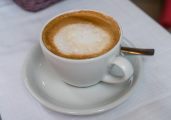 cappuccino coffee cup on the white table