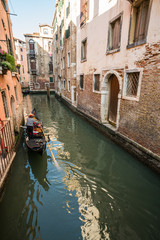 Fototapeta na wymiar gondola cruises through canal in Venice, Italy.