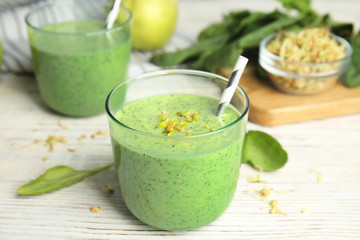 Green buckwheat smoothie on white wooden table