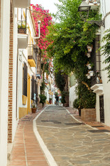 Marbella, Spain - August 26th, 2018. Typical old town street with Spanish architecture in Marbella, Costa del Sol, Andalusia, Spain, Europe