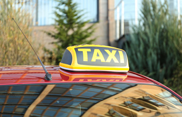 Roof light with word TAXI on car outdoors
