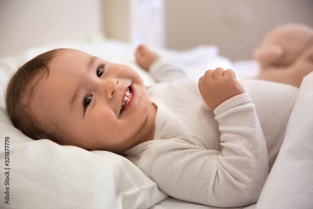 Wall mural cute little baby lying in comfortable crib. bedtime