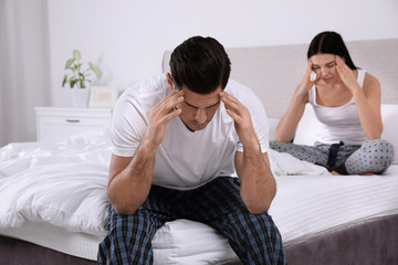 Naklejka na ściany i meble Unhappy couple with relationship problems after quarrel in bedroom