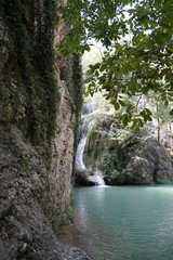 waterfall flowing into a mountain lake