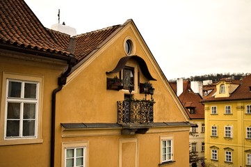 A little black bohemian balcony of a traditional house with a religious icon (Prague, Czech Republic, Europe)