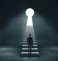 Businessman walking to open door in form keyhole. © peshkova