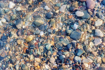 Colorful rocks and pebbles under the clear water