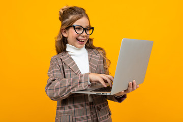 caucasian girl in a business suit with a laptop in hands