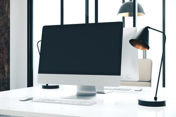Modern designer desktop with blank computer screen