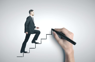 Fototapeta premium Businessman walking on drawing stairs.