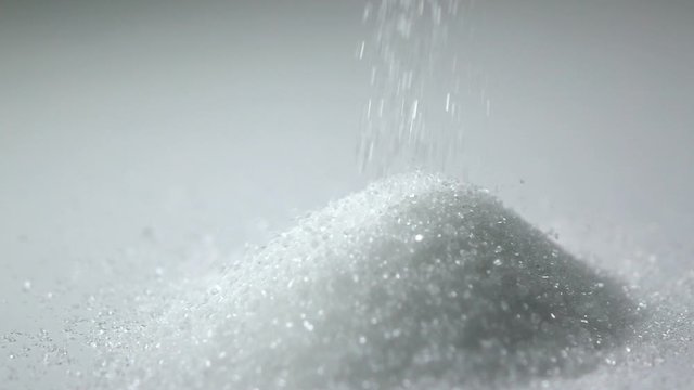 Slow motion shot : Close up White sugar Droping on white dish.