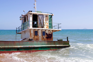 old abandoned ship on the shallows in the sea