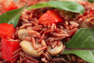 Tasty brown rice with bell pepper and mushroom, closeup