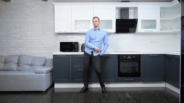 young handsome man dancing in the kitchen. lifestyle