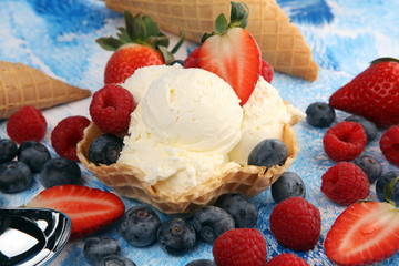 Vanilla ice cream scoops with fresh berries. Strawberries, raspberries with ice cream