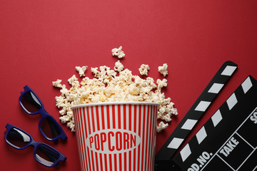 Flat lay composition with delicious popcorn on red background