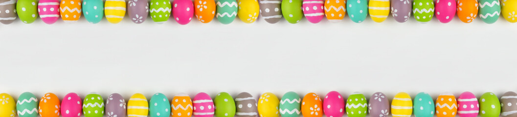 Easter banner with colorful Easter Egg double border over a white background. Above view with copy space.
