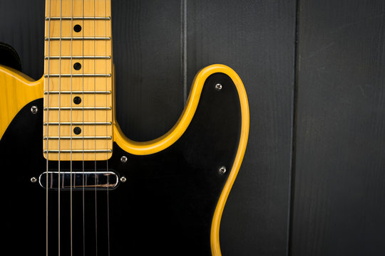 Close-up of classic electric guitar, neck with frets, microphone and steel strings