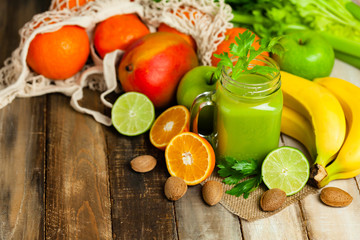 Healthy eating, food and vegetarian diet concept - jar of fresh fruity juice or smoothie. Antioxidant detox beverage. Clean organic ingerdients. Close up, wooden background, copy space