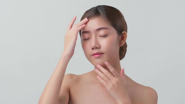 4k uhd facial beauty skin concept asian female attractive and healthy skin closeup hand touch softy face with care and freshness white background