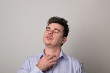 Attractive young man. Positive man with an earring in his ear.