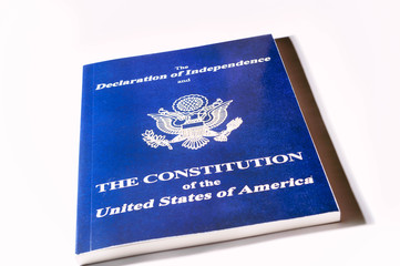 high angle view of blue book with declaration of independence and constitution of united states of america on white background