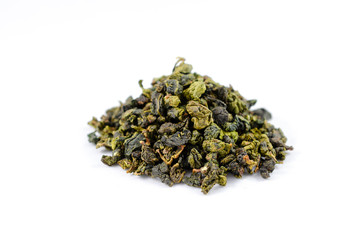 Pile of dry green tea oolong leaves on a white background close-up.