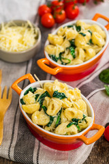 Parmesan Spinach Macaroni and Cheese on Wooden Background. Selective focus.