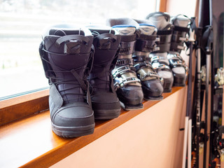 Ski and snowboard boots rental, skis and poles. Skiing equipment rented. Close up.