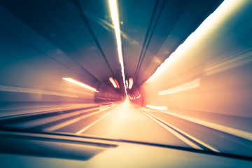 Abstract traffic background. Dark underground tunnel with blurred light tracks. Motion blur