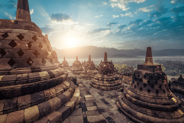 Amazing view of stone stupas at ancient Borobudur Buddhist temple against beautiful landscape on background. Great religious architecture. Magelang, Central Java, Indonesia