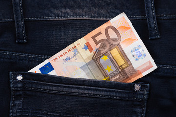 Fifty euro banknote money in pocket jeans pants background texture. 50 euro close up