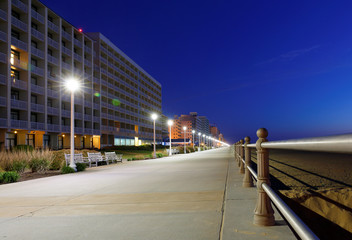 The Boardwalk of Virginia Beach after Sunset. The Boardwalk is 28-feet wide and stretches three miles along the Virginia beach and is popular for vacation.