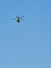 Helicopter carrying a heavy cargo to an isolated spot