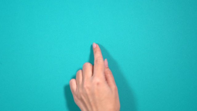Closeup top view of beautiful female hand making gesture as if scrolling pages in browser of digital mobile device with touch screen.