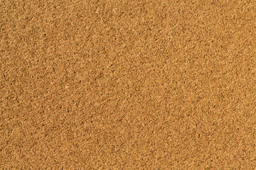 Brown yellow cork-board macro texture and background.