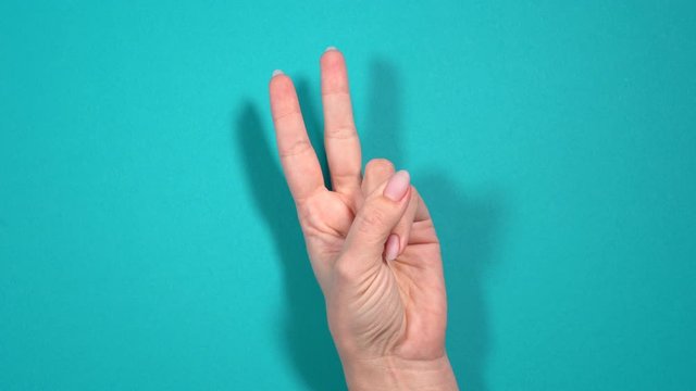 Closeup view of female manicured hand counting from zero to five using fingers. 
