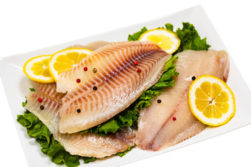 Whitefish Tilapia Fish Raw Fillet Isolated on White Background. Selective focus.