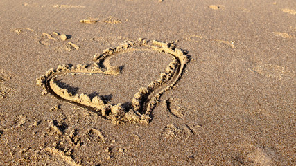 love heart drawn on sand
